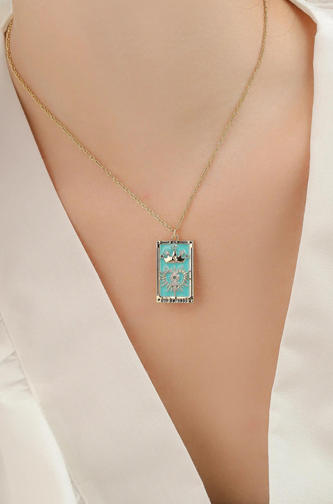 A tarot card necklace featuring a rectangular pendant inscribed at the bottom.