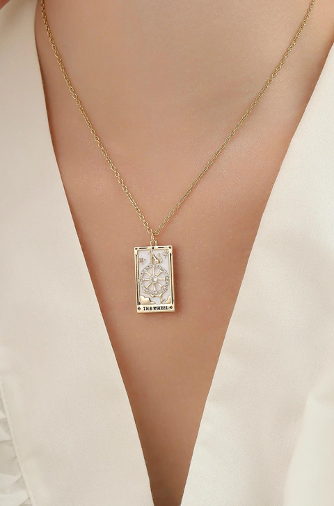 A tarot card necklace featuring a rectangular pendant inscribed at the bottom.