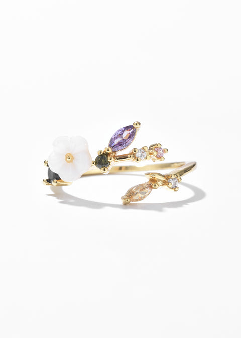 An open-ended floral ring band, accented by a cluster of multicolored gemstones.