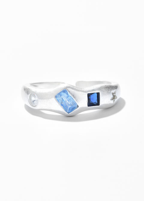 An adjustable ring with a clear gemstones in various hues and cuts.