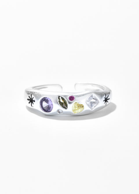 An adjustable ring with a clear gemstones in various hues and cuts.