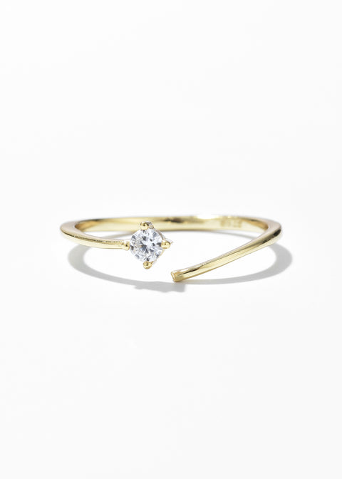 A gold band ring with a single diamond set on a split and open ring design.