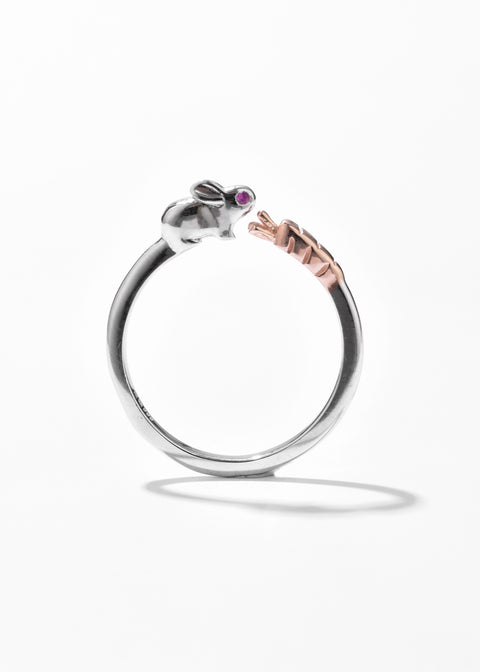 A bunny ring with open ring design, and small purple gemstone eyes set on a silver band.