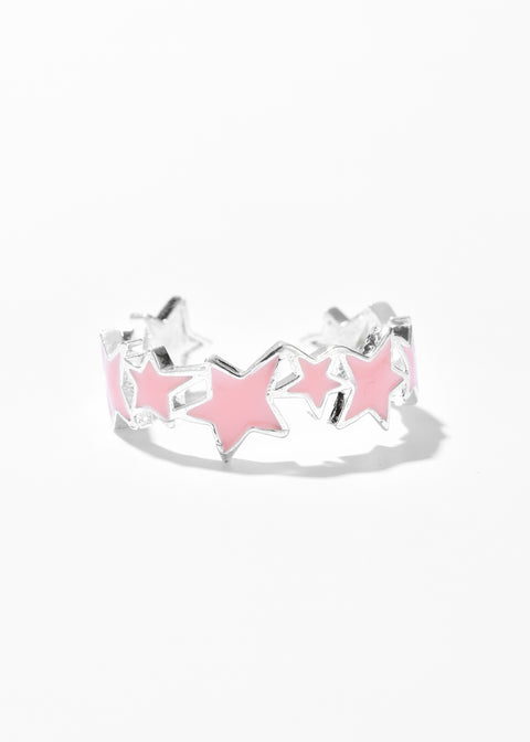 A star ring with pink accents in an open ring design.