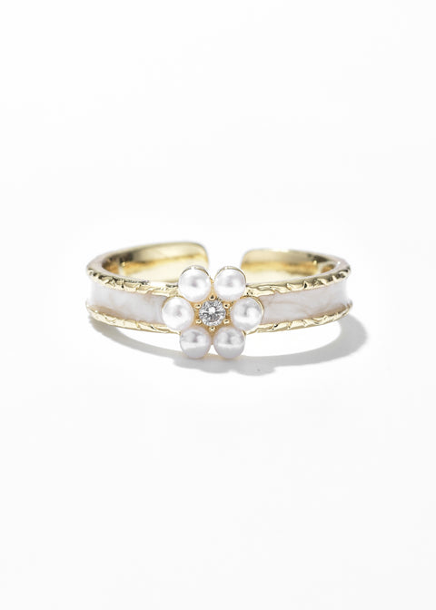 A Belle Inspired Princess Ring with a beige enamel band and a central floral design made up of small white pearls.