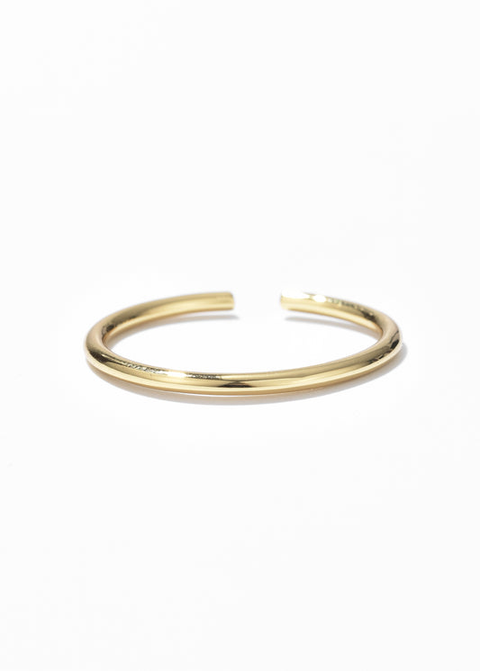 An open ring in a gold band ring design with sleek, shiny finish.