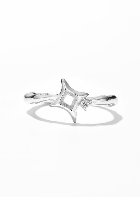 One of the couple rings set, in a star ring design with clear gem at the center.