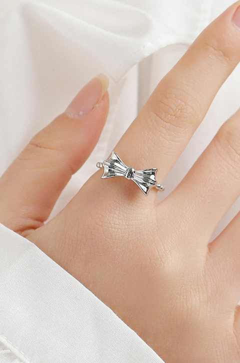 Bow Ring with a split shank, crafted in a shiny, metallic finish.