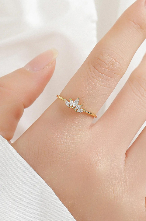 A crown ring with pointed, sparkling marquise-cut stones on top.