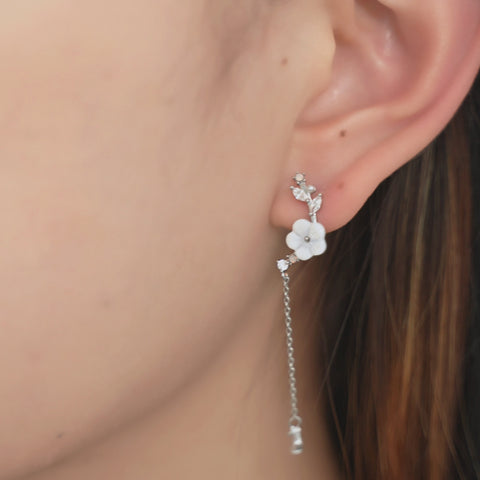 Vine earrings featuring flower design with crystal details and long chain.