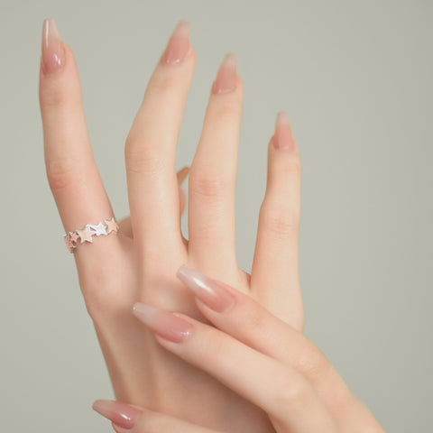 A star ring with pink accents in an open ring design.