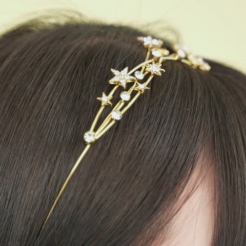 A star headband with small, sparkling stars and clear crystals.