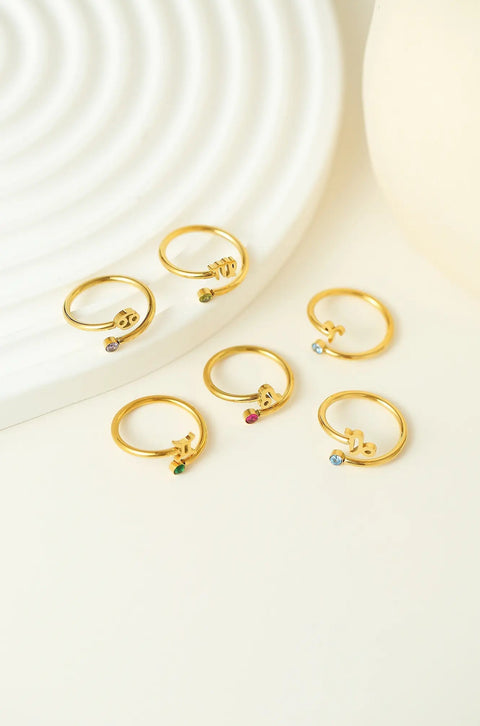 A Pisces ring with the zodiac sign emblem and a small gemstone.