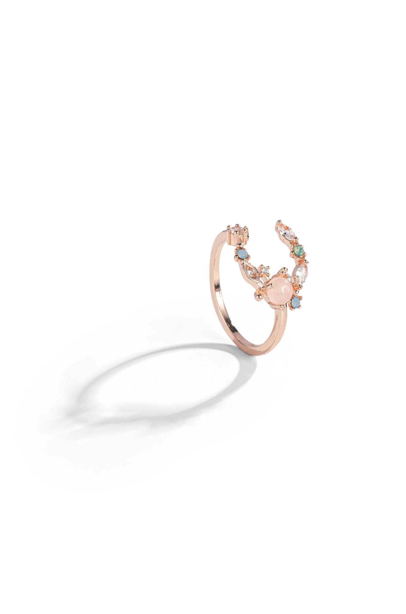 A crescent moon ring design with an open ring style and set with various sized gemstones.
